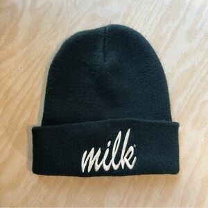 Black beanie with white font “Milk”
